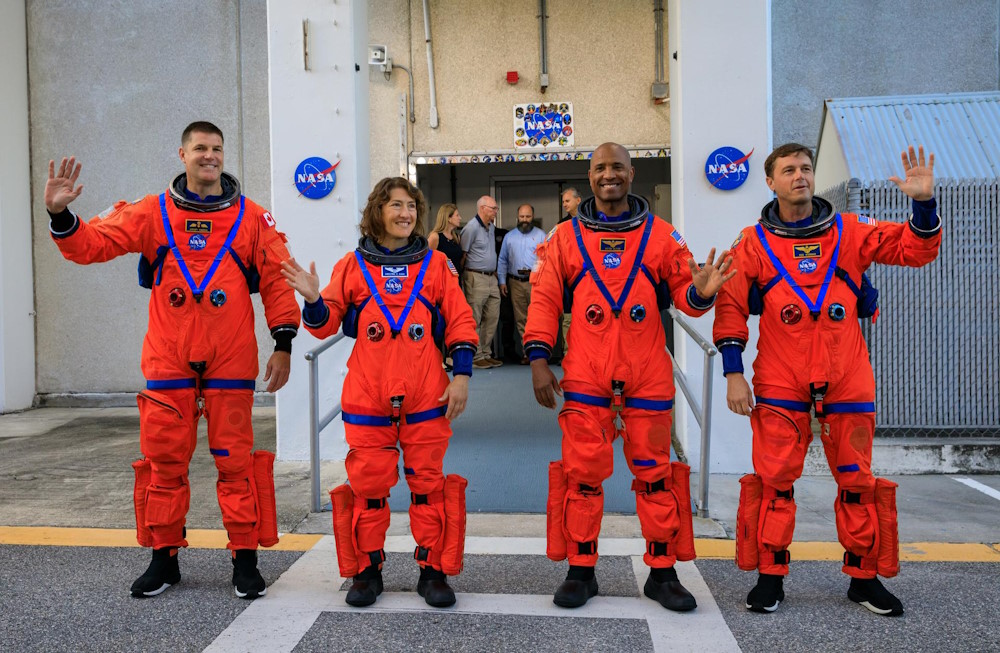 Artemis II crew members (from left) CSA (Canadian Space Agency) astronaut Jeremy Hansen, and NASA astronauts Christina Koch, Victor Glover, and Reid Wiseman walk out of Astronaut Crew Quarters inside the Neil Armstrong Operations and Checkout Building to the Artemis crew transportation vehicles prior to traveling to Launch Pad 39B as part of an integrated ground systems test at Kennedy Space Center in Florida on Wednesday, Sept. 20, to test the crew timeline for launch day. Credit: NASA